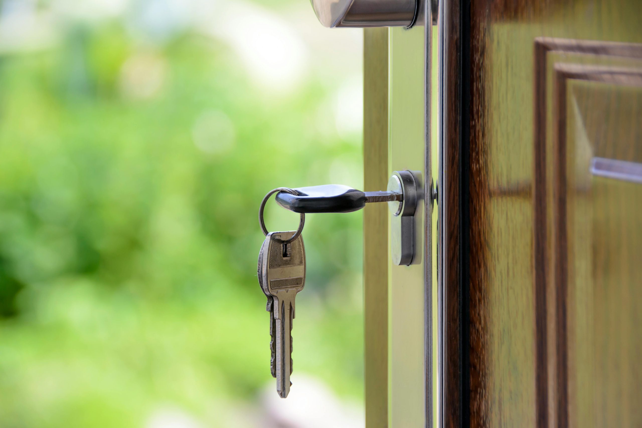 Image of a key in the front door of a house
