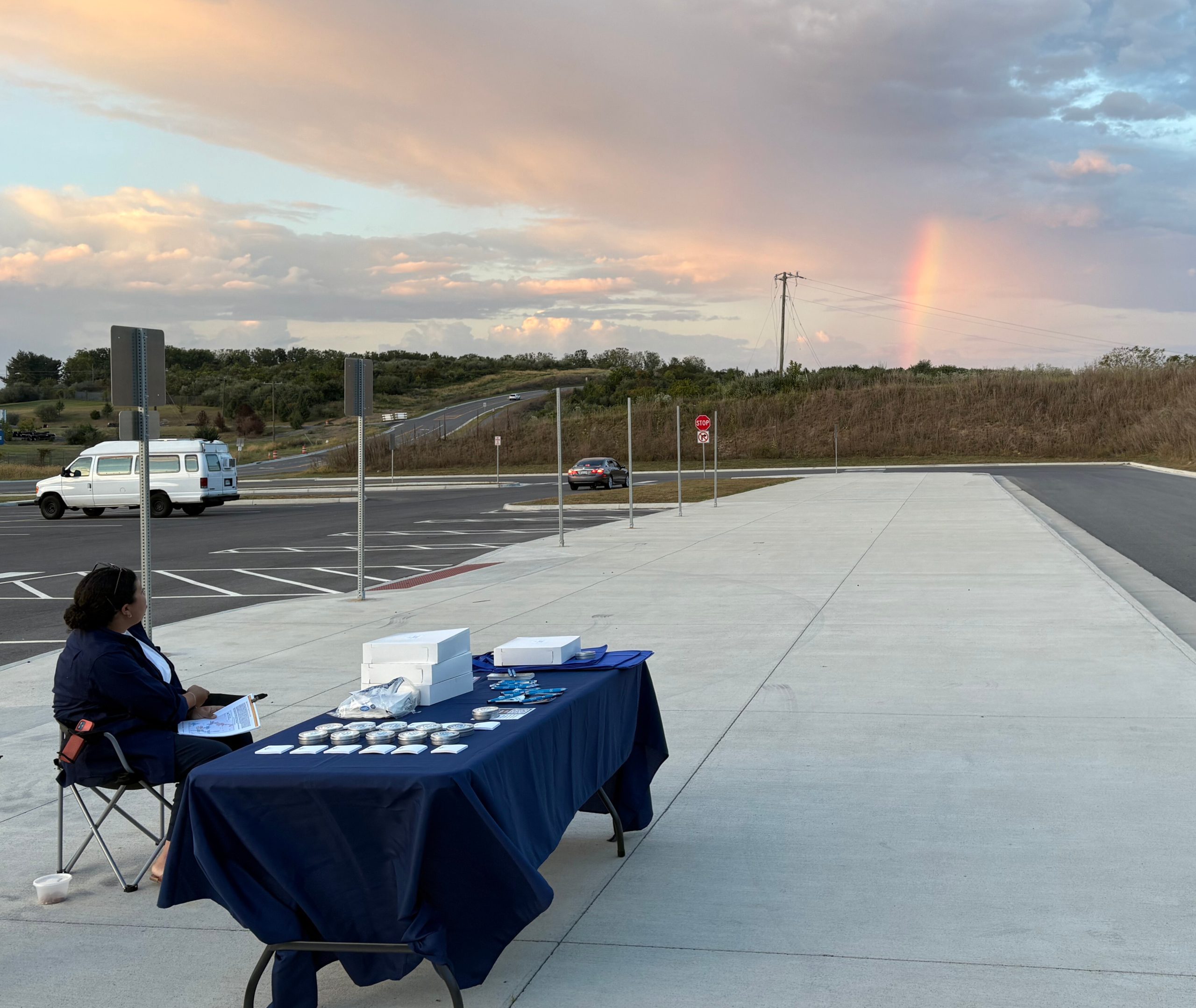 Person sitting at a table at a bus stop